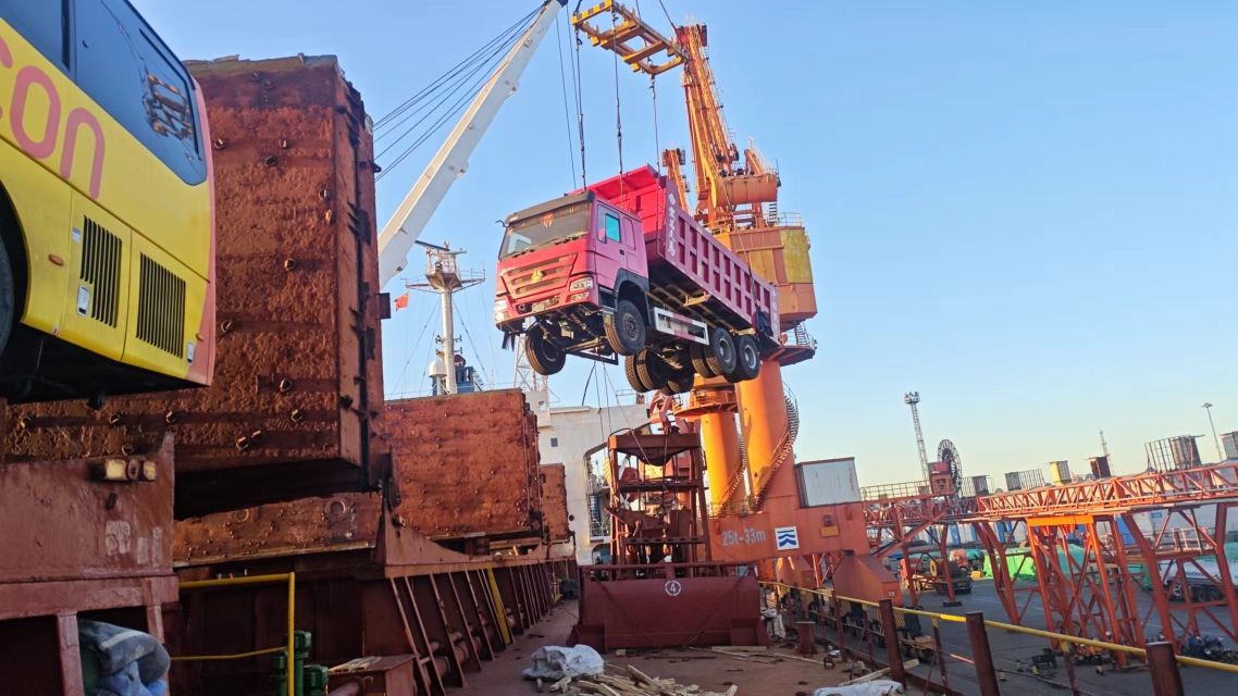 HOWO 371 dump truck secured inside RORO cargo deck during loading at Tianjin Port, China used truck export