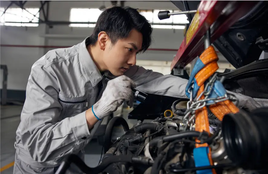 Inspecting frame rails and fifth wheel on used Chinese tractor truck before export
