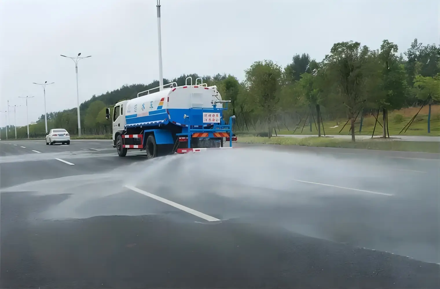 A water truck in action on a mine site or construction site in Africa, spraying water.