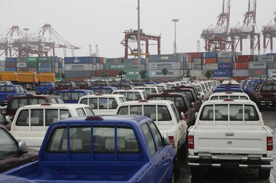 Used pickup trucks being loaded for export from China to African ports